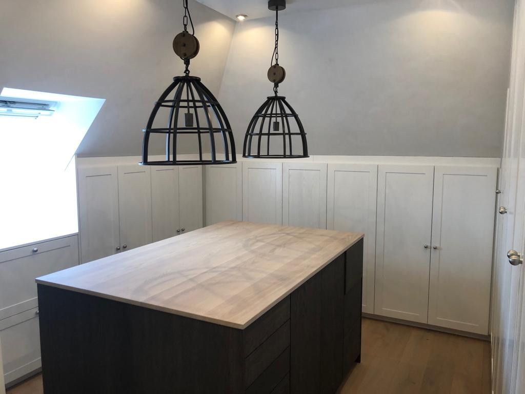 Kamer met rondom maatwerk kasten en eiland in het midden